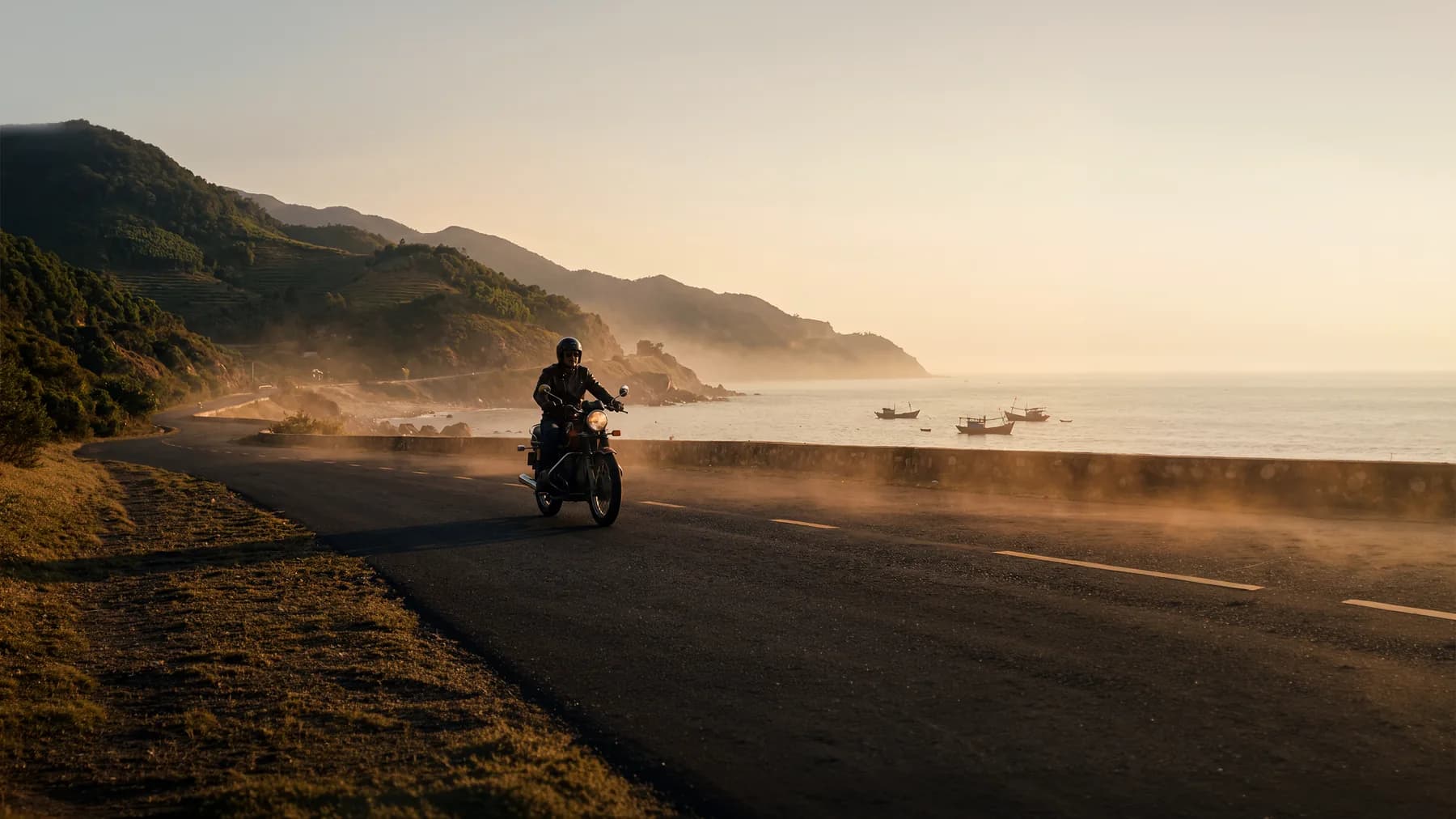A motorcyclist on a coastal road in Vietnam